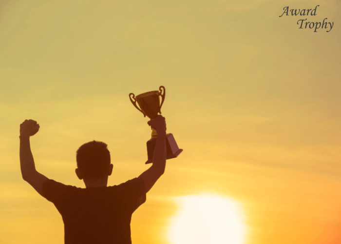 raising a trophy towards the sun